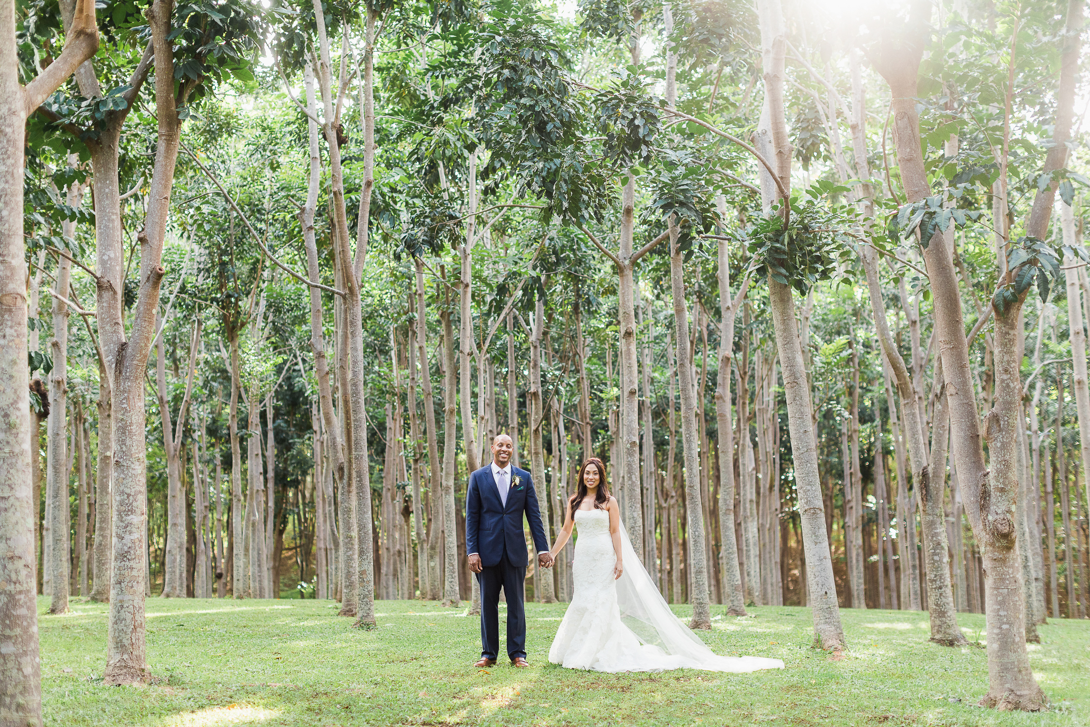 Wedding photo of bride and groom in hardwood forest 